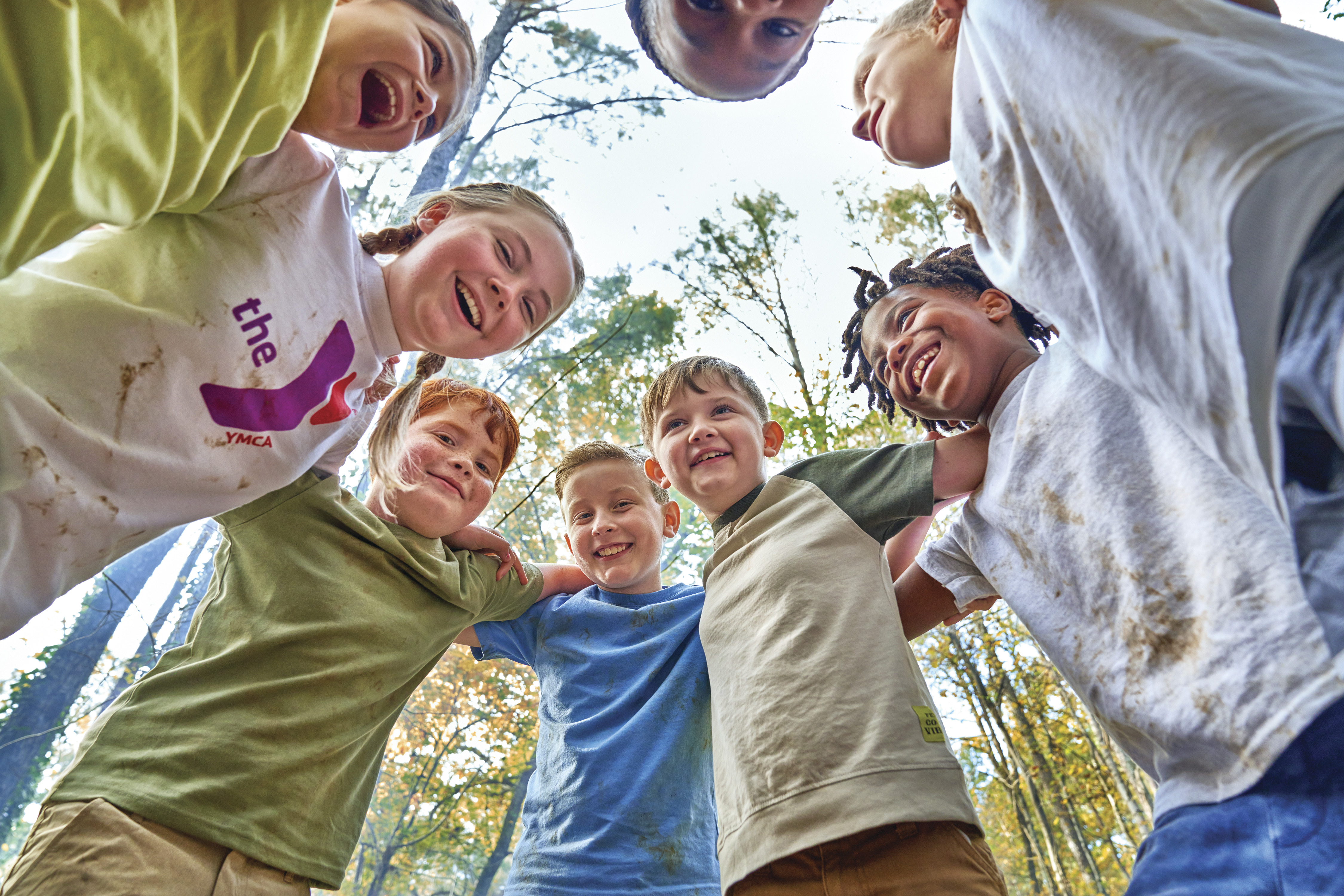 Kids in a circle looking down at camera