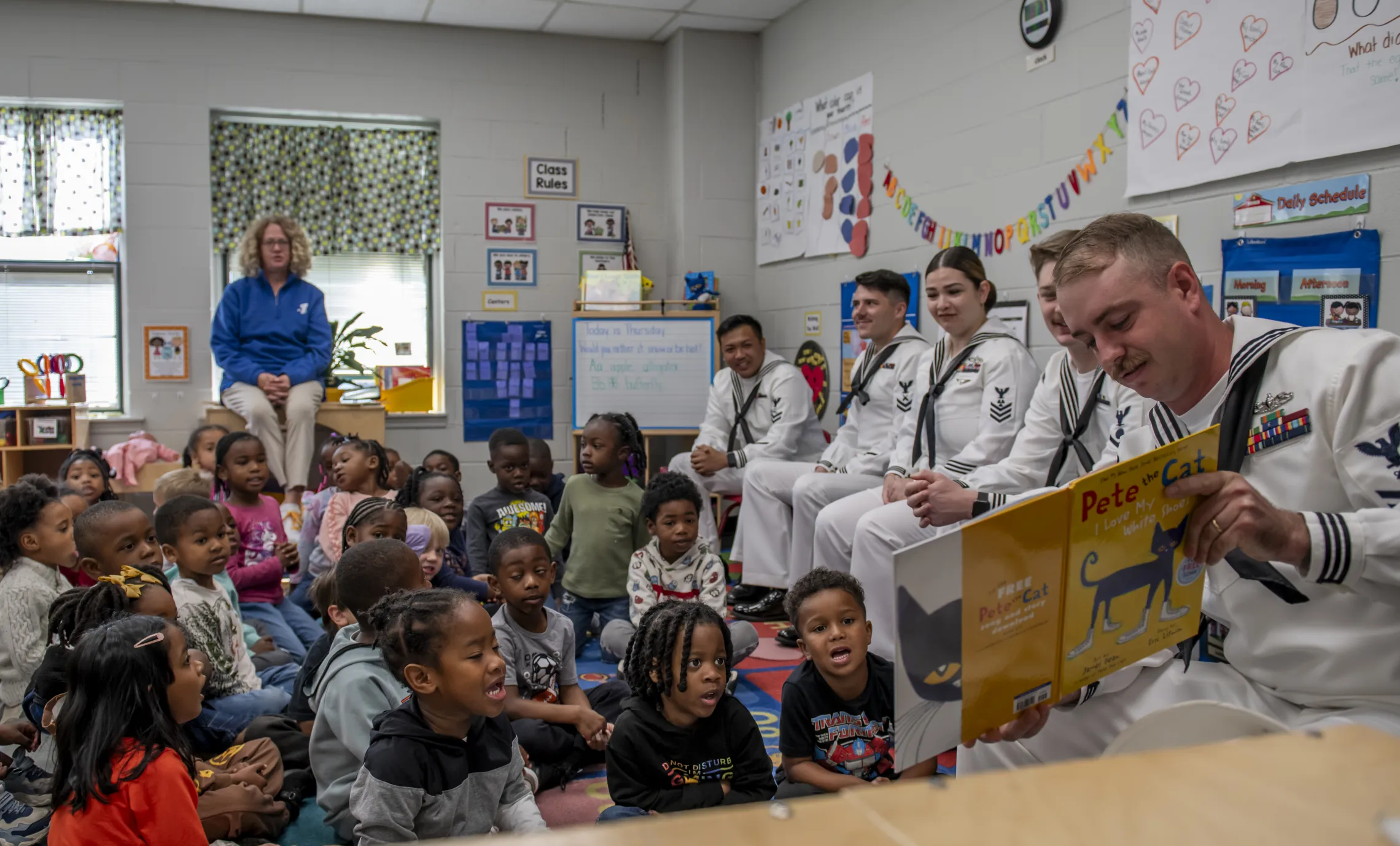 navy sailors reading to children